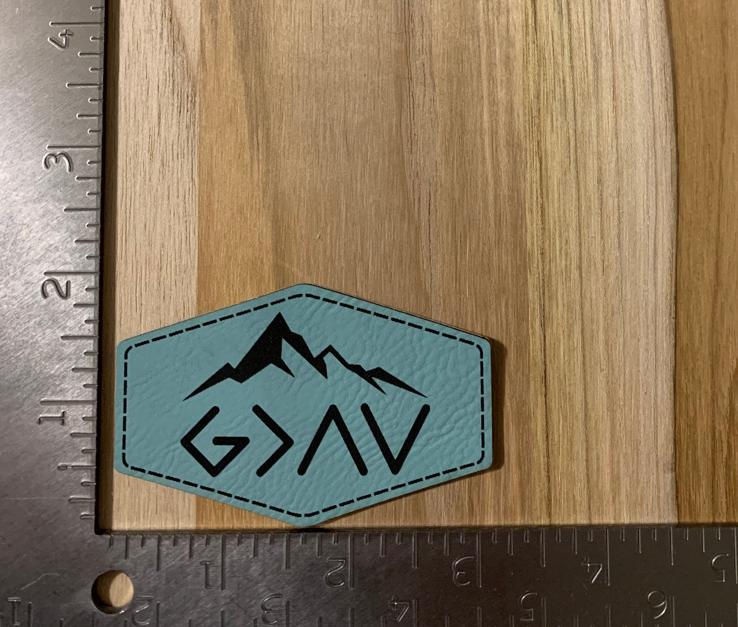 God is greater above than below blue leather patch