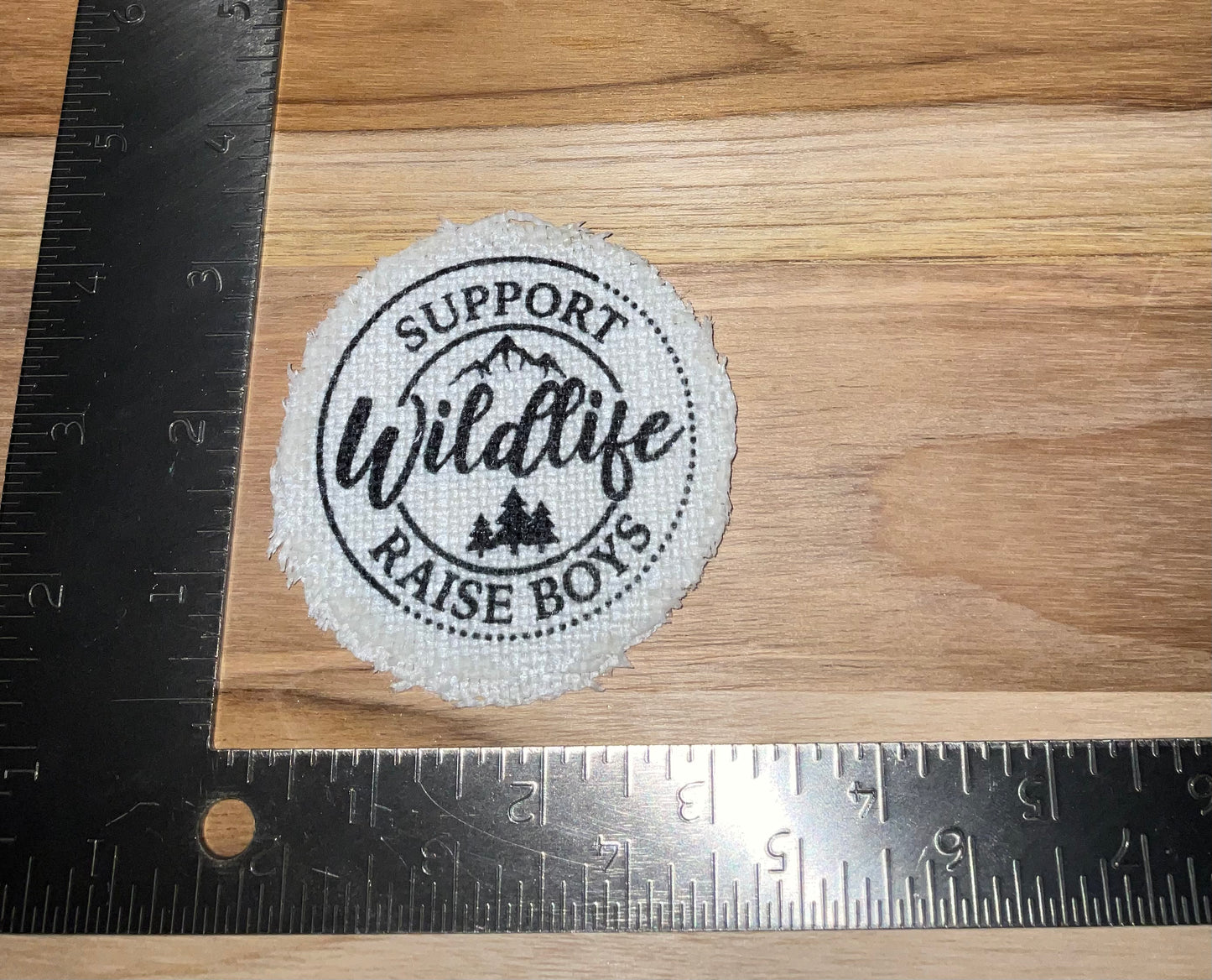 Her patch "support wildlife raise boys"