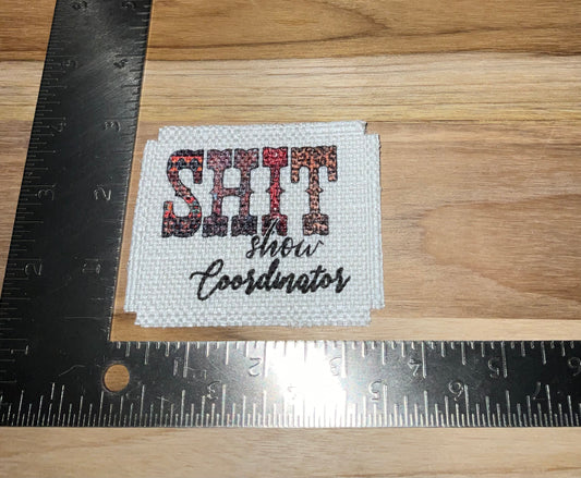 Her patch "shit show coordinator"