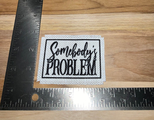 Her patch "somebody’s problem" outlined